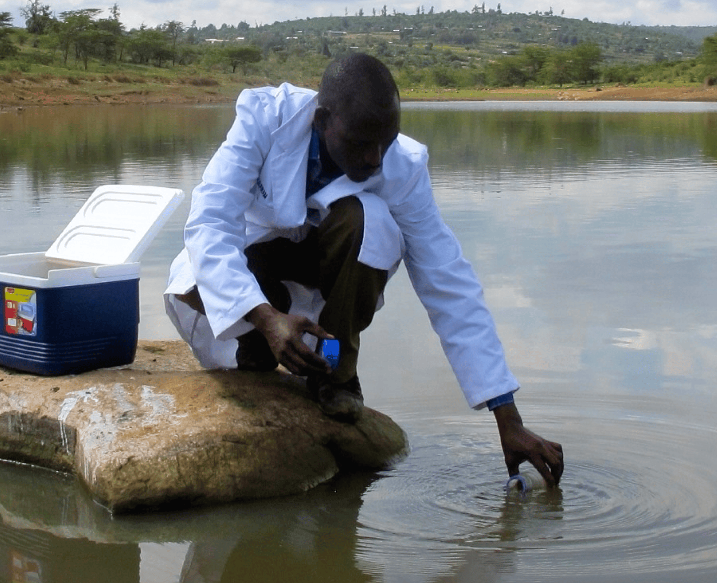 A person collecting water related data in the field.